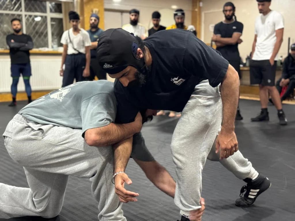 Close view of two wrestlers practising a standing hold