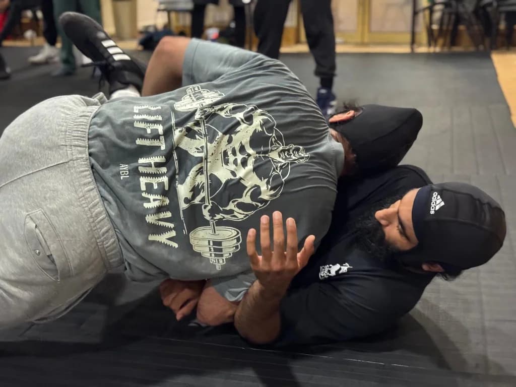 Two academy wrestlers practising a groundwork hold
