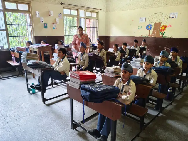 Pupils seated at classroom desks during a lesson