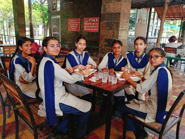 Pupils sharing a learning activity around a table